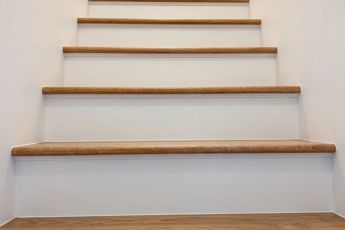 Rebuilt basement stairs with new wood treads and painted risers, Innov Builders project in Ashland, MA