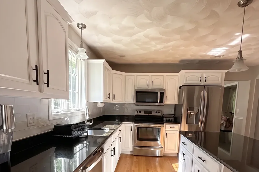 Quartz countertops and cabinetry in a Greater Boston kitchen remodel by Innov Builders
