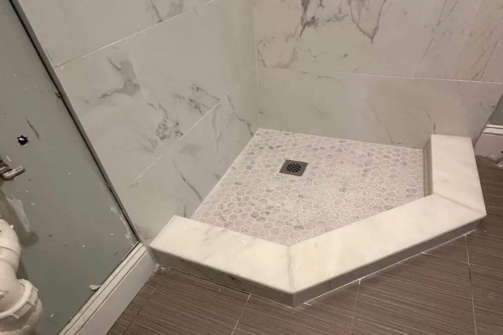 Floating vanity in a compact New England bathroom remodeled by Innov Builders