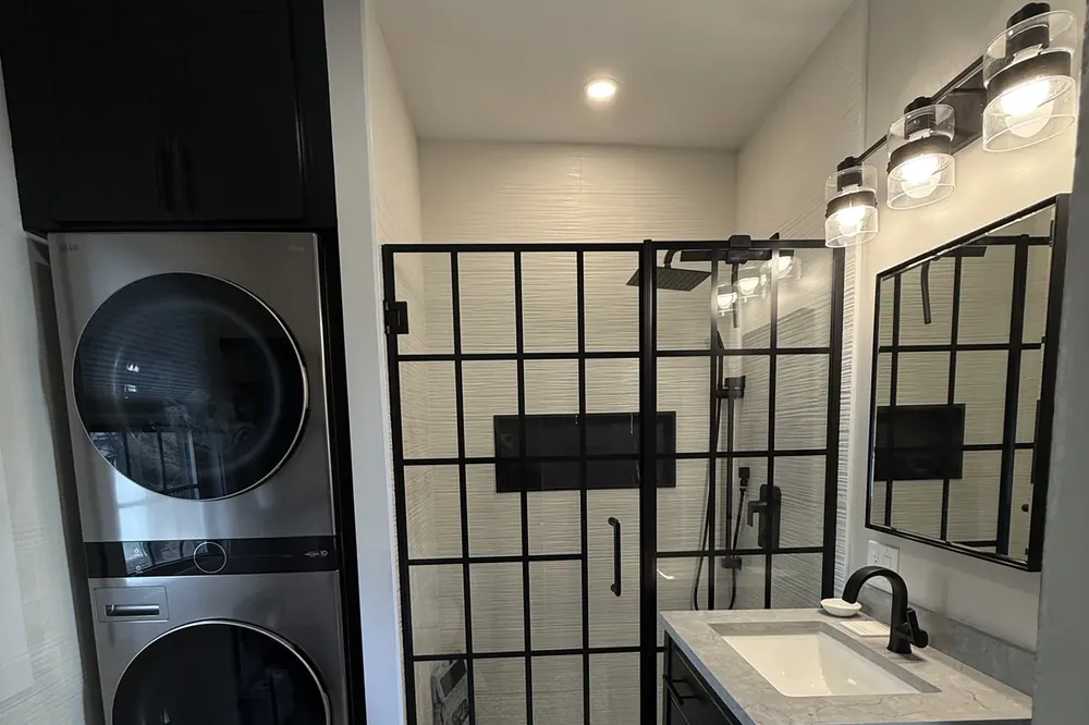 Small bathroom with a glass walk-in shower that makes the space feel larger, remodel by Innov Builders in Massachusetts