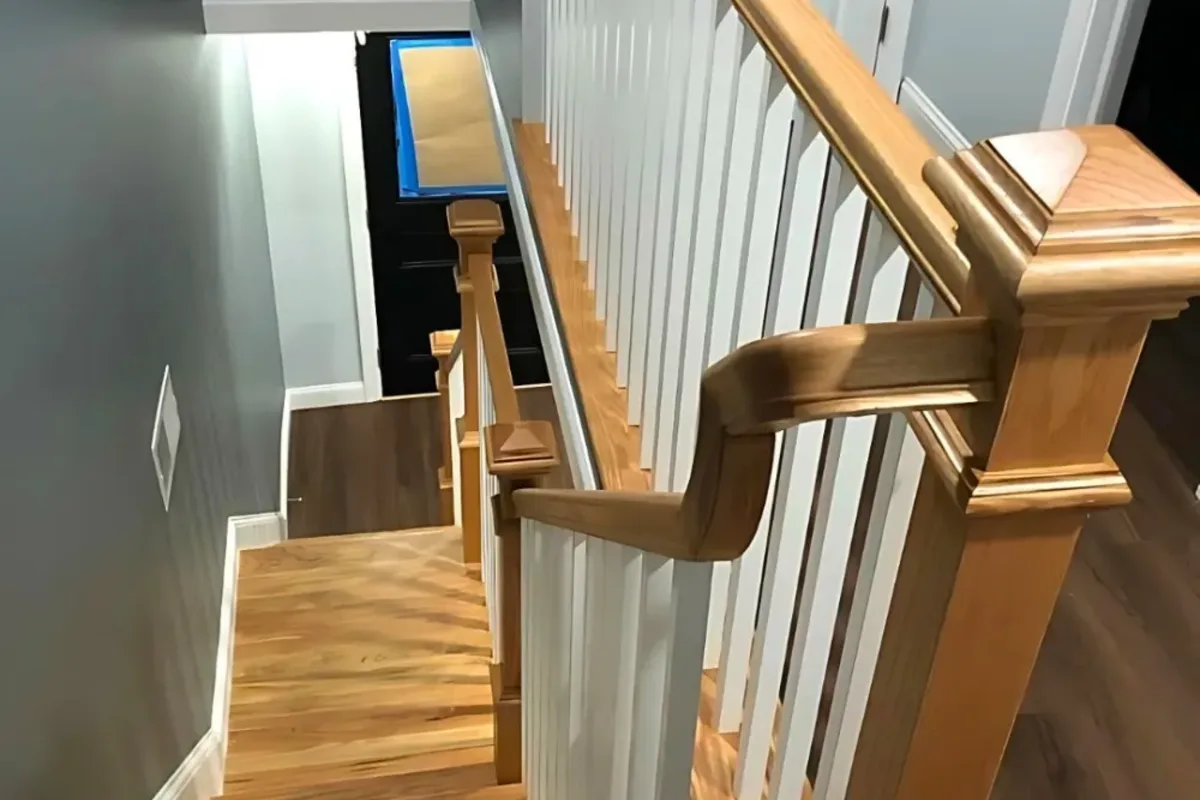 Finished staircase with new balusters and refinished treads by Innov Builders in Reading, MA