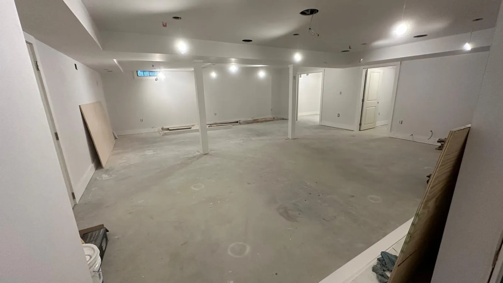 Large basement in progress after drywall and recessed lighting, before flooring, Innov Builders project in North Andover, MA