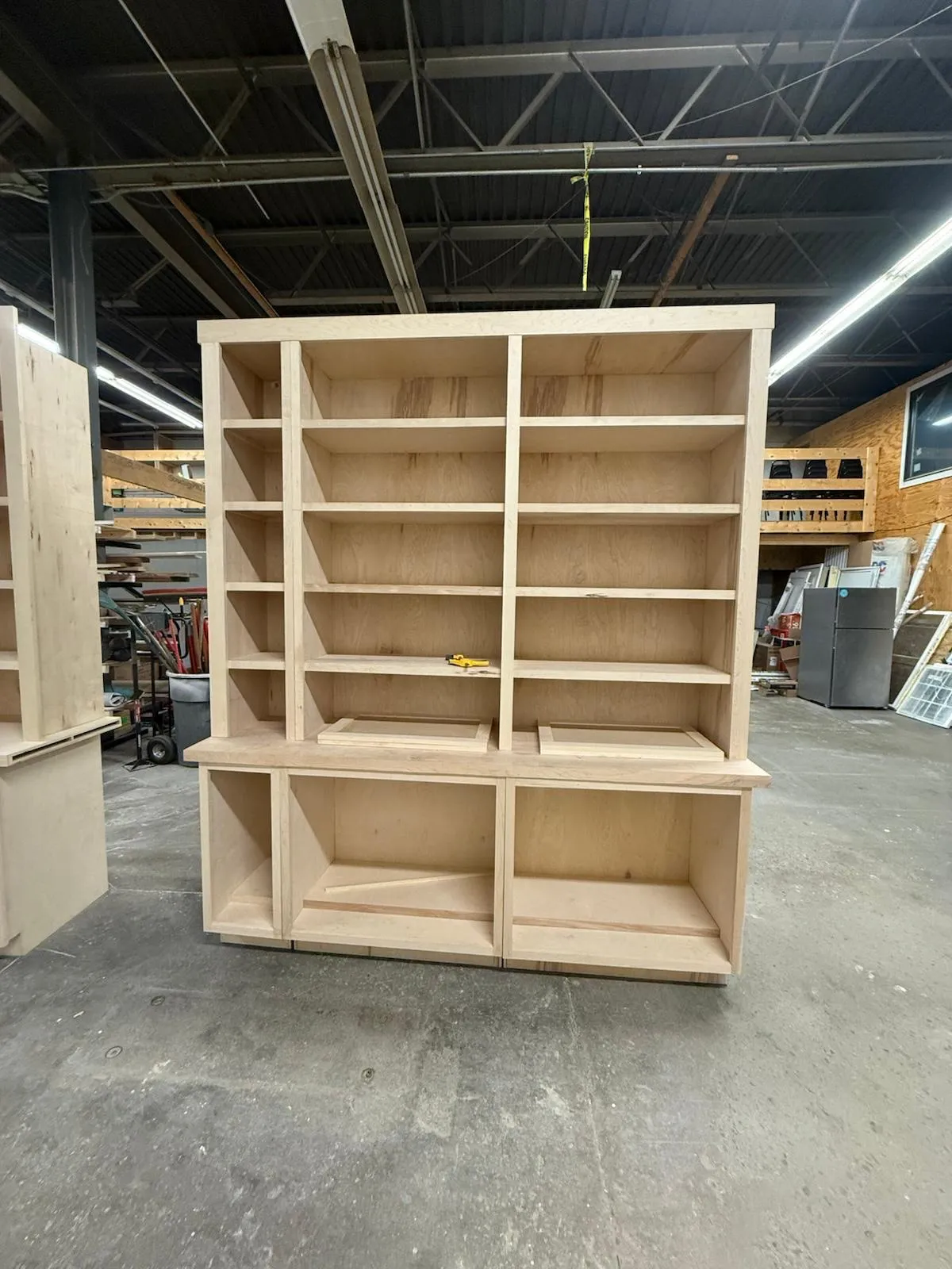 Custom built-in shelving units assembled in the Innov Builders shop before installation in a North Andover, MA home