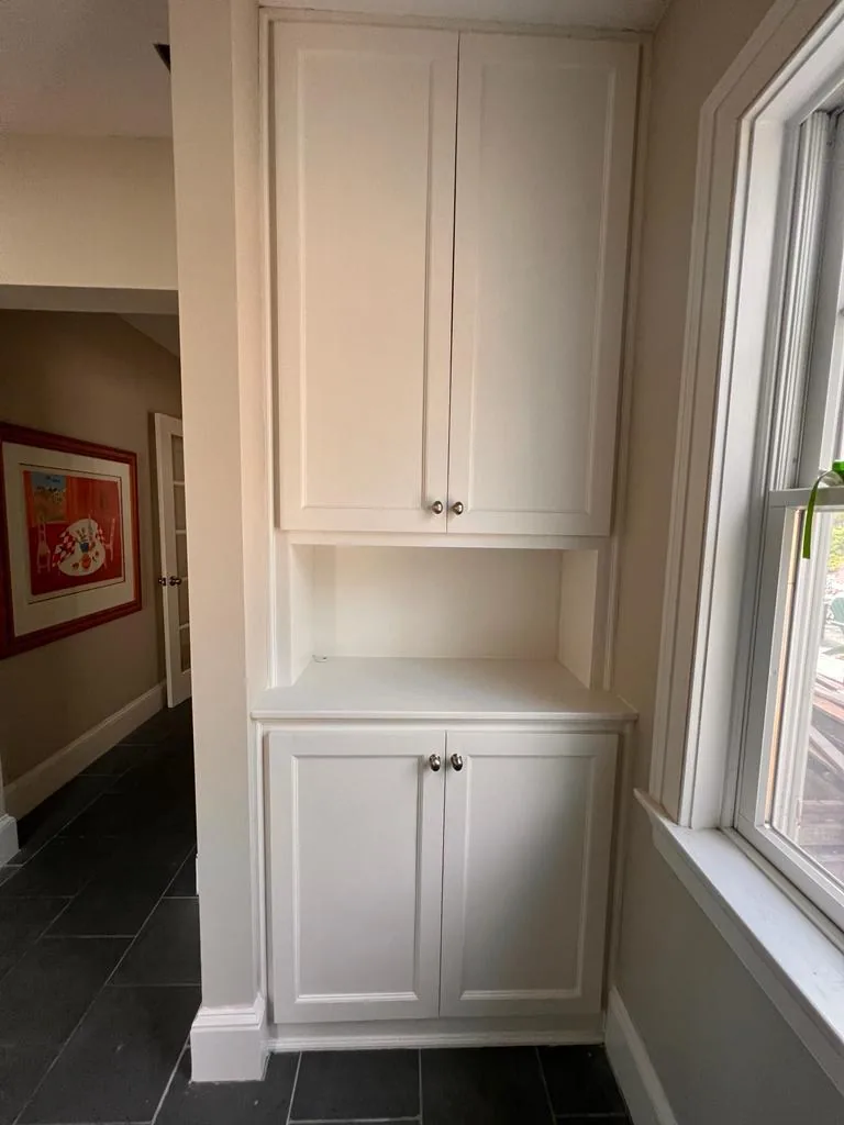 White custom built-in cabinetry with an open shelving niche in a Wakefield MA home by Innov Builders