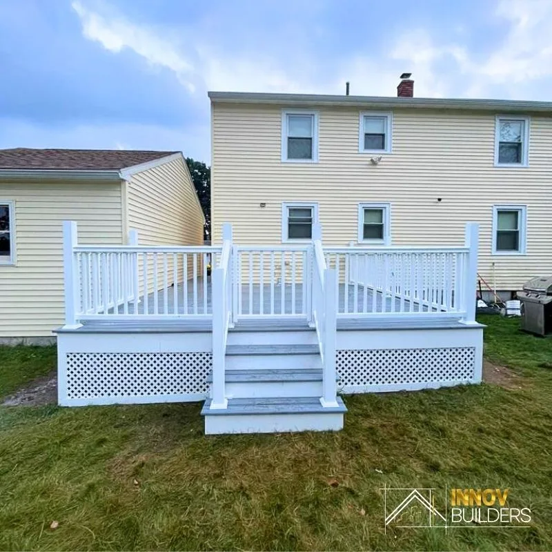 Deck replacement with white railing and lattice skirting in Wakefield, MA